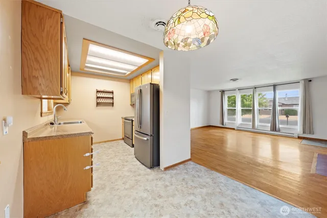 a kitchen with stainless steel appliances granite countertop a refrigerator and a stove
