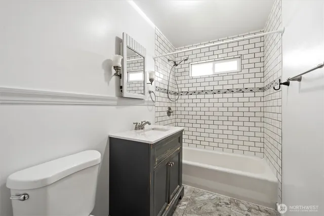 a bathroom with a sink toilet and a mirror