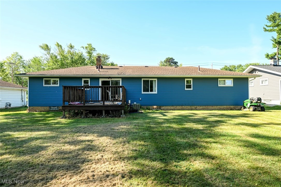 13150 Sprague Road Cleveland, OH 44130 - Photo 38 of 39 Rear view of house with a wooden deck, a lawn, and a chimney