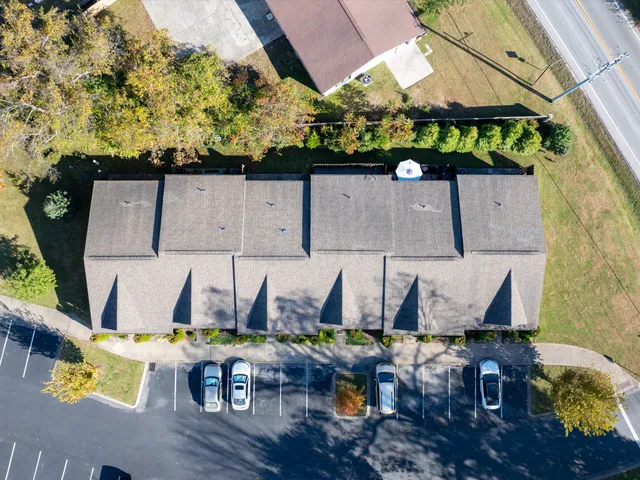 an aerial view of a swimming pool with outdoor seating