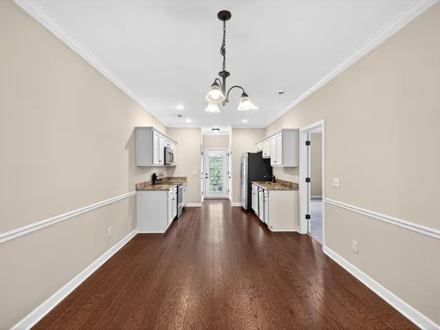 a view of a kitchen with a sink stainless steel appliances and cabinets