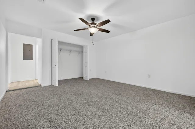 a view of an empty room with closet