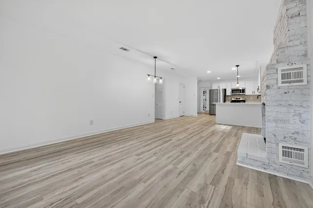 a living room with a fireplace and a floor to ceiling window