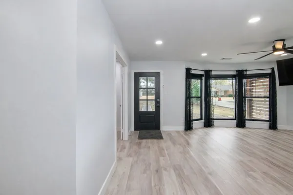 a kitchen with kitchen island a counter top space a sink and a ceiling fan