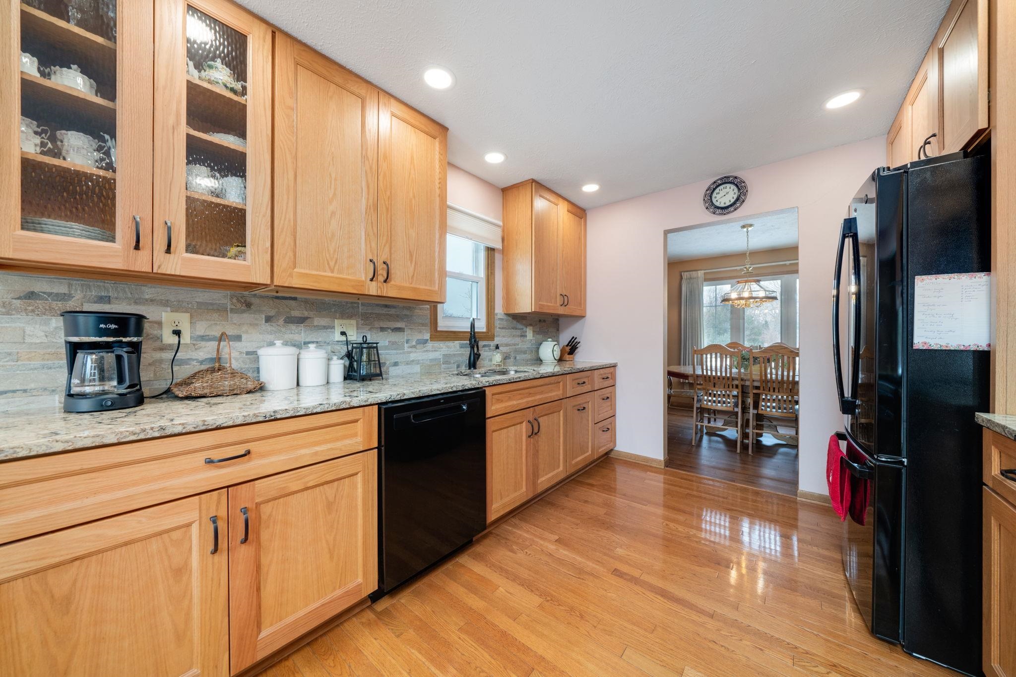 6395 Greystone Roscoe, IL 61073 - Photo 11 of 32 a kitchen with stainless steel appliances granite countertop a refrigerator a sink a stove and oven