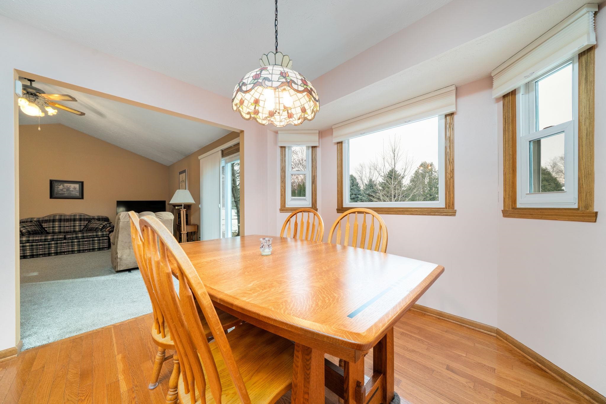 6395 Greystone Roscoe, IL 61073 - Photo 14 of 32 a view of a dining room with furniture window and wooden floor