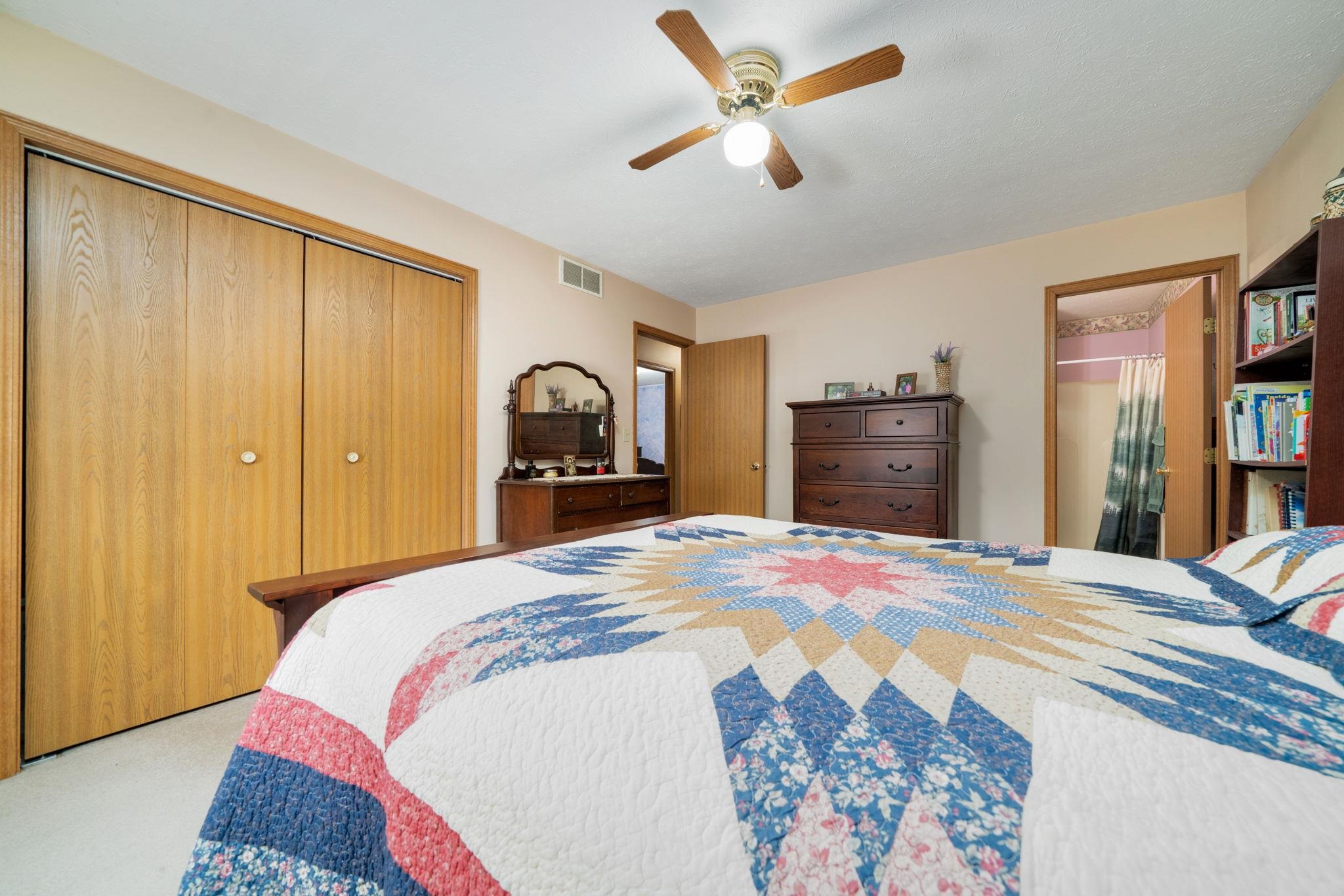 6395 Greystone Roscoe, IL 61073 - Photo 18 of 32 a bedroom with a bed and a chandelier