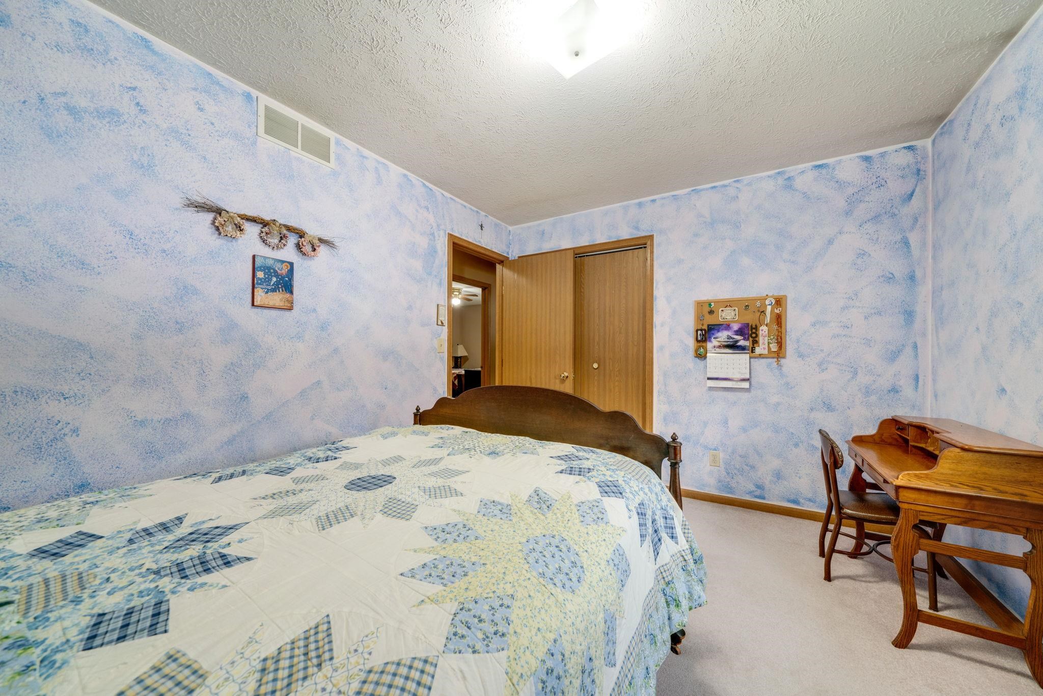 6395 Greystone Roscoe, IL 61073 - Photo 20 of 32 a bedroom with a bed and chair