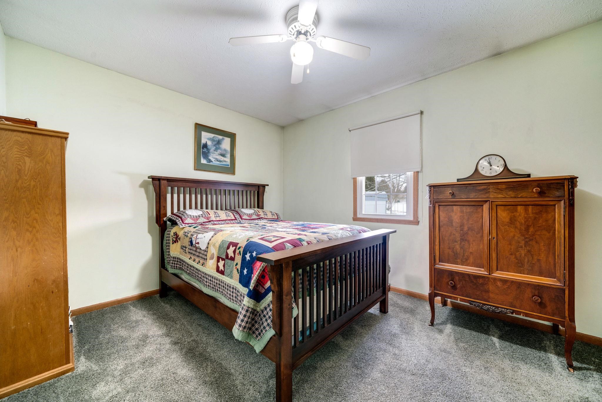 6395 Greystone Roscoe, IL 61073 - Photo 23 of 32 a bedroom with a bed and a chandelier