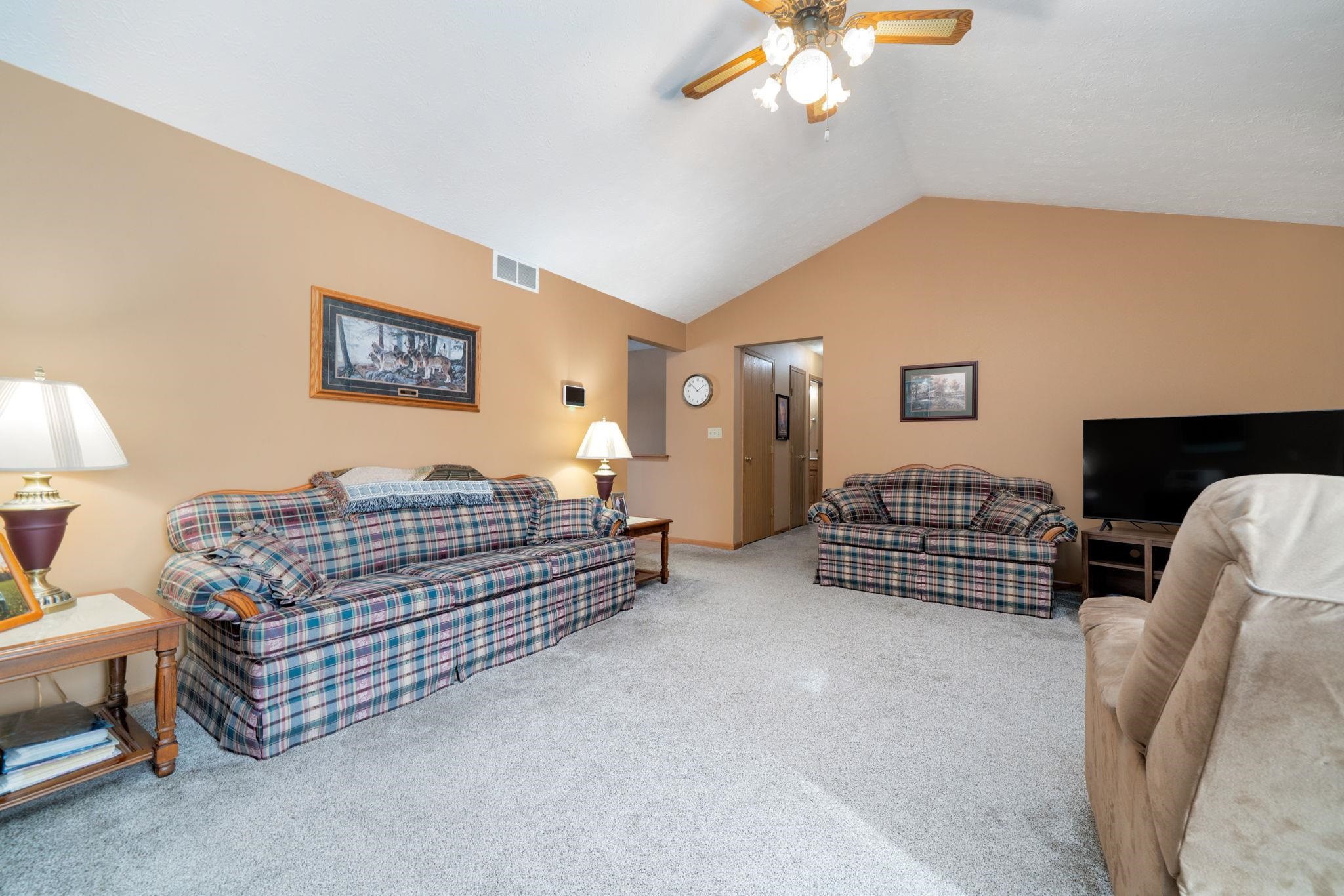 6395 Greystone Roscoe, IL 61073 - Photo 10 of 32 a bedroom with furniture and a chandelier