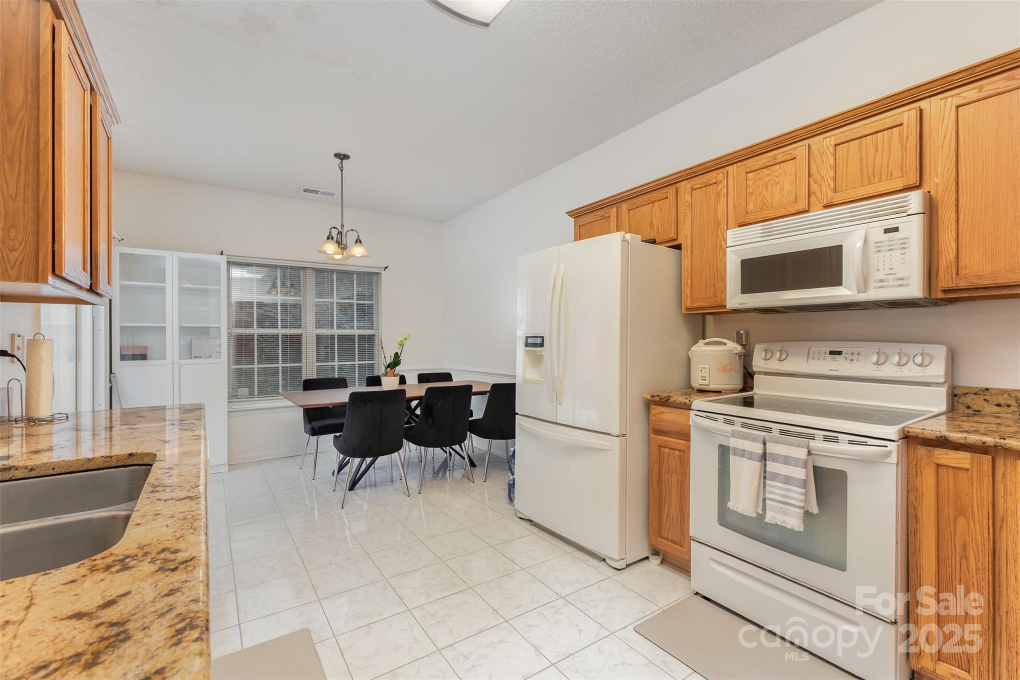 13521 Michael Lynn Road Charlotte, NC 28278 - Photo 12 of 34 a kitchen with stainless steel appliances granite countertop a refrigerator and a stove top oven
