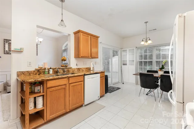 a kitchen with a sink and chairs