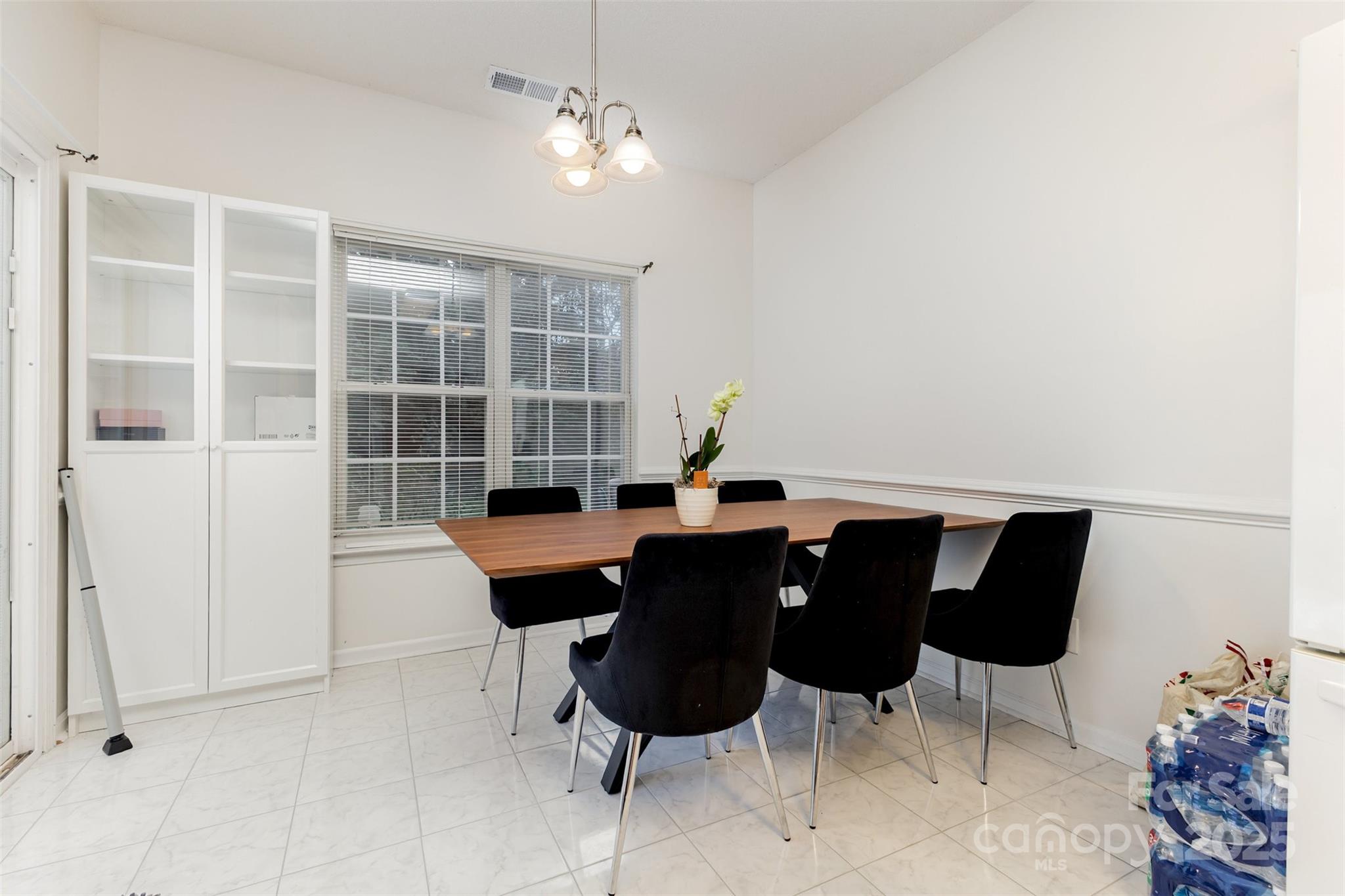 13521 Michael Lynn Road Charlotte, NC 28278 - Photo 16 of 34 a living room with furniture windows and a chandelier