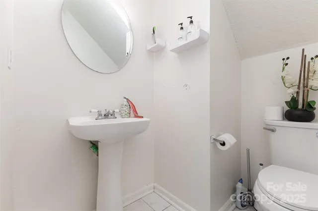 a bathroom with a sink toilet and a mirror