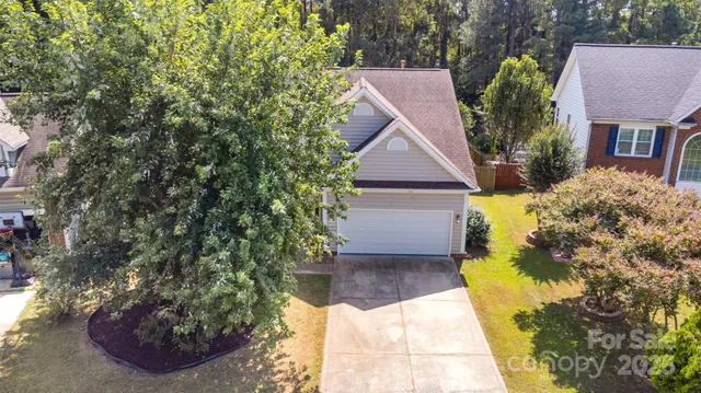 a aerial view of a house with a yard and potted plants