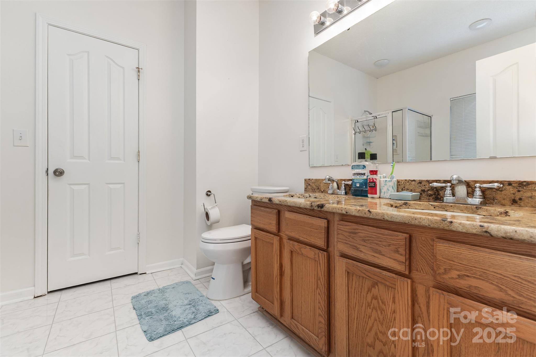 13521 Michael Lynn Road Charlotte, NC 28278 - Photo 23 of 34 a bathroom with a toilet sink and mirror