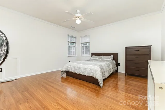 a spacious bedroom with a bed and a closet