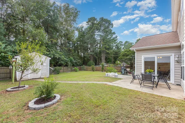 a swimming pool with outdoor seating and yard