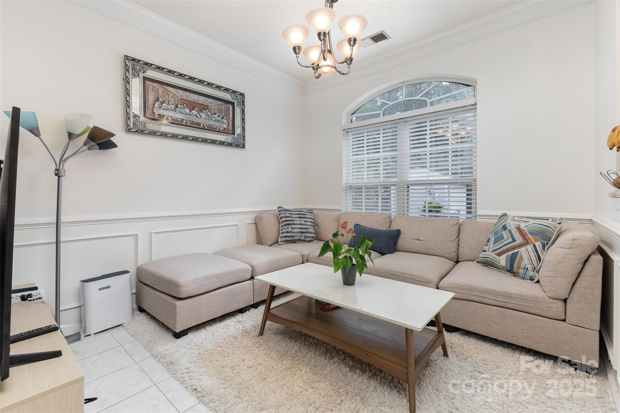13521 Michael Lynn Road Charlotte, NC 28278 - Photo 10 of 34 a living room with furniture a chandelier and a window