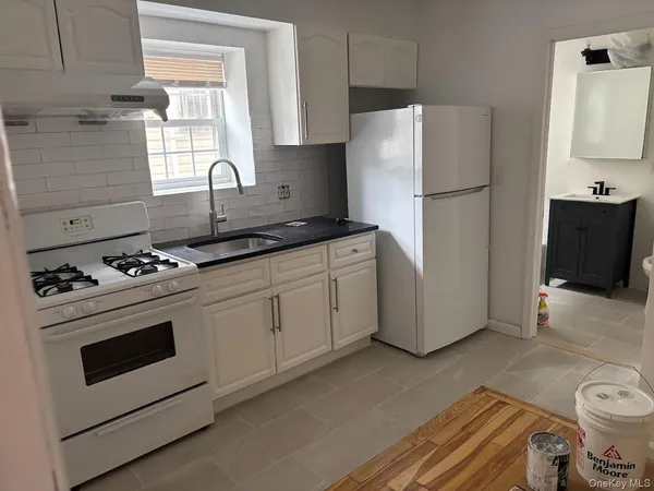 a kitchen with a stove a refrigerator and a sink
