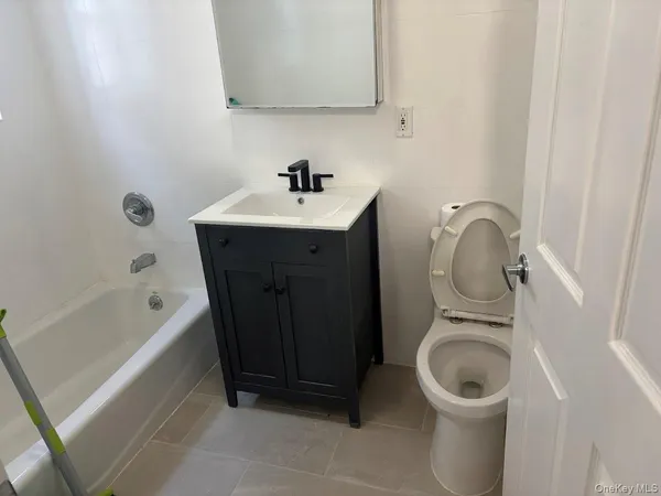 a bathroom with a sink a toilet and bathtub