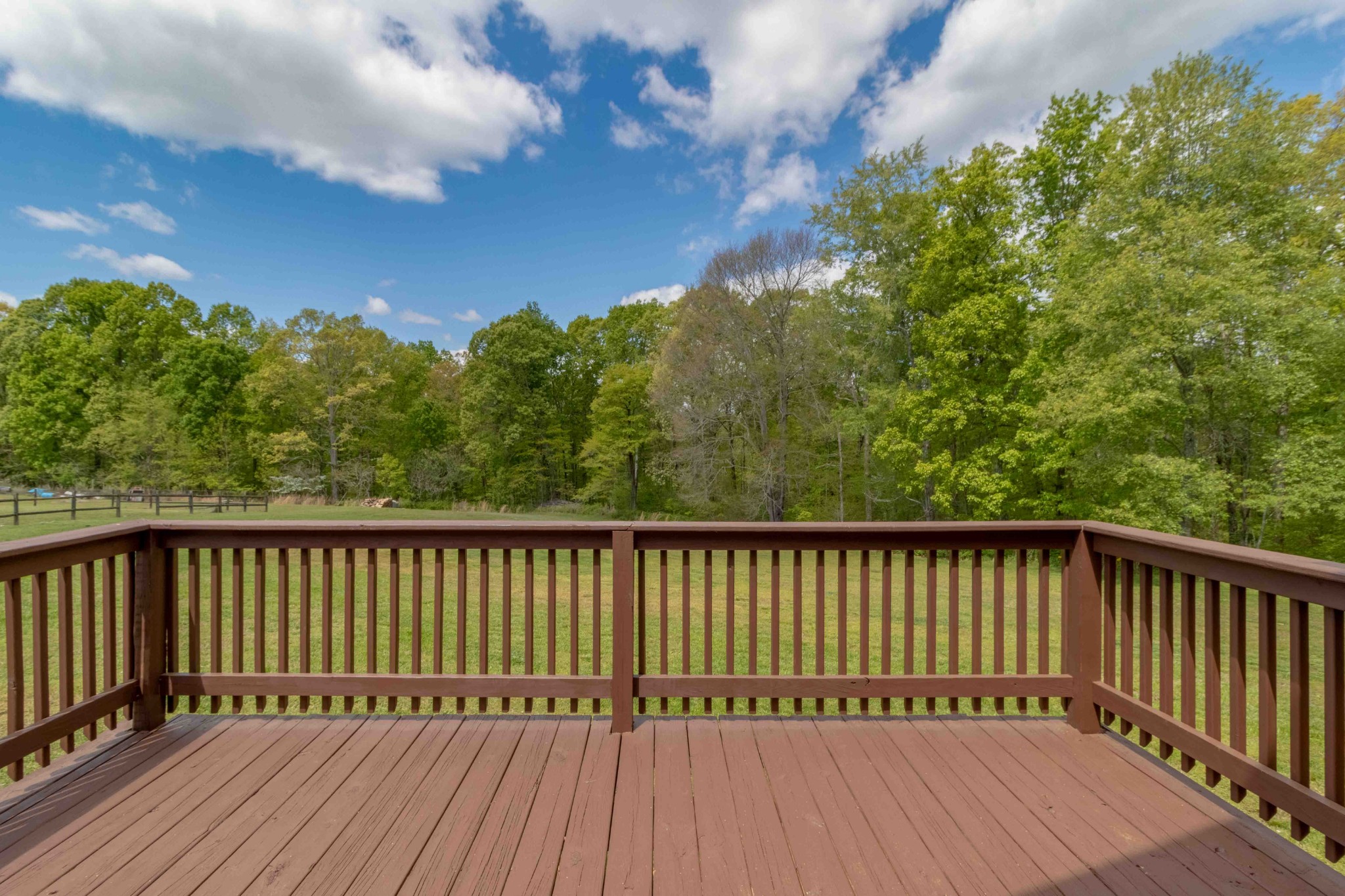 946 Hayes Ridge Road Indian Mound, TN 37079 - Photo 22 of 23 a balcony with wooden floor and trees in the background