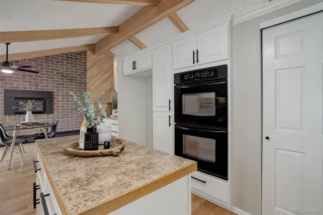 a kitchen with kitchen island a stove and a sink