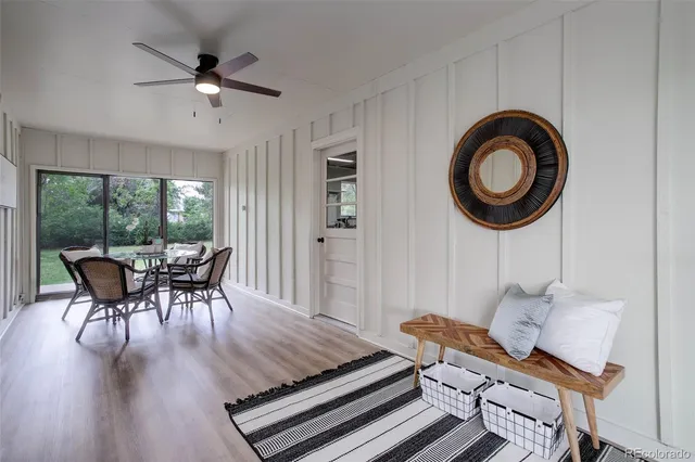a dining room with furniture a chandelier and wooden floor