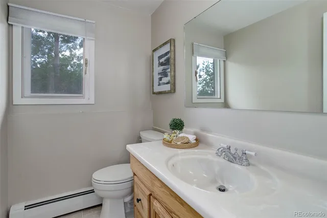 a bathroom with a sink mirror and toilet