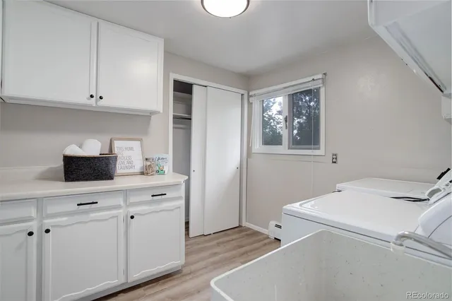 a kitchen with a sink cabinets and wooden floor