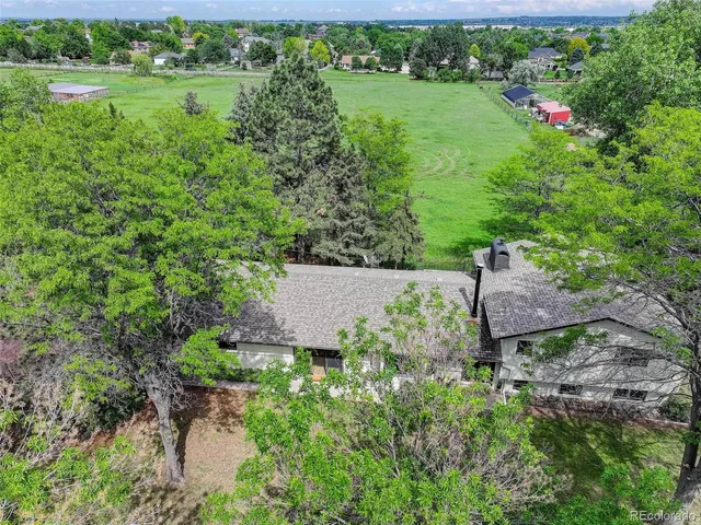 an aerial view of a house with yard and outdoor seating