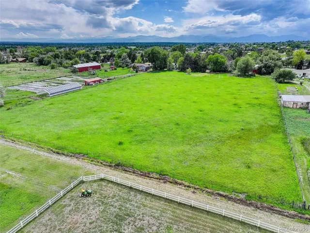 a view of a garden with a building in the background