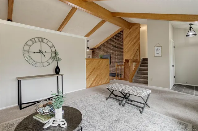 a living room with furniture and a mirror