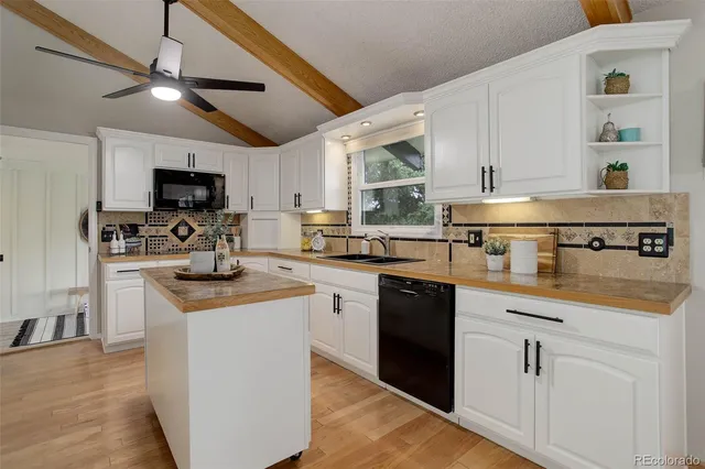 a kitchen with stainless steel appliances granite countertop a stove sink and cabinets