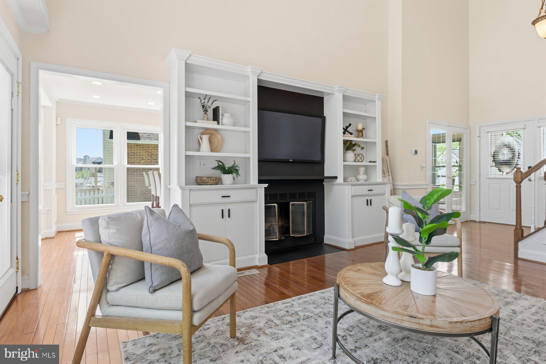 14215 Greenview Drive Laurel, MD 20708 - Photo 7 of 35 a living room with furniture a flat screen tv and a table