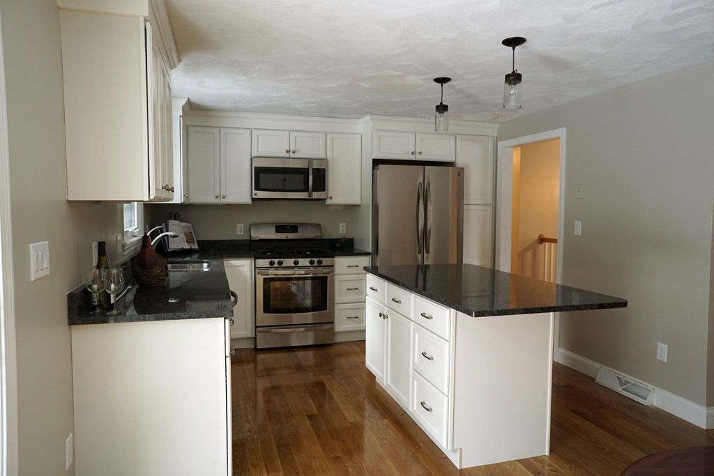 38 Blanchard Road Wilmington, MA 01887 - Photo 5 of 21 a kitchen with stainless steel appliances a refrigerator stove and microwave