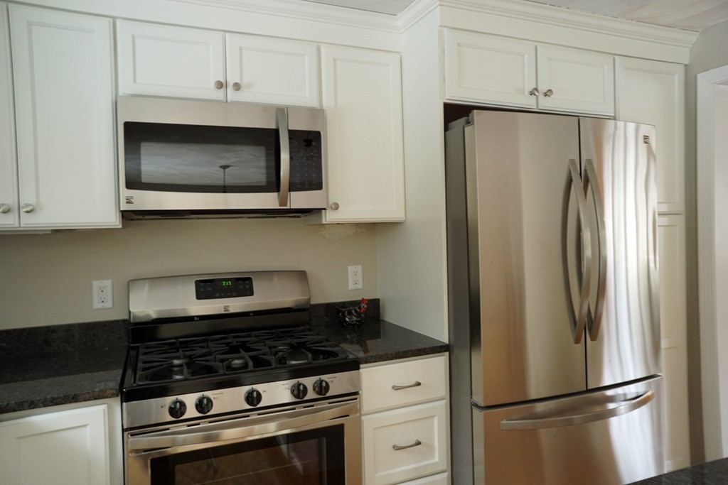 38 Blanchard Road Wilmington, MA 01887 - Photo 6 of 21 a kitchen with stainless steel appliances granite countertop a refrigerator stove and microwave