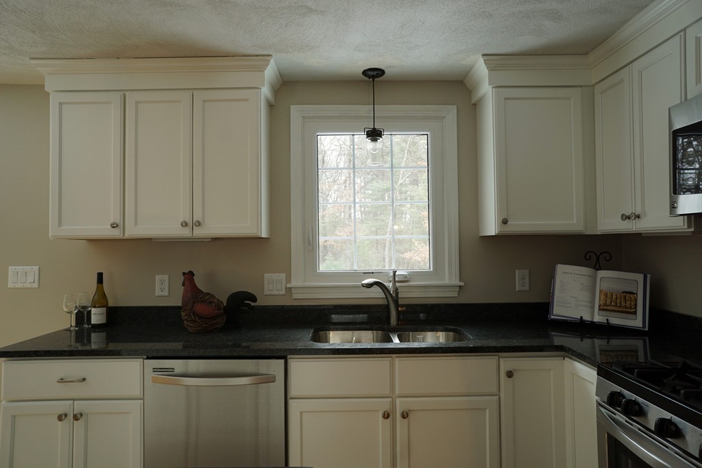 38 Blanchard Road Wilmington, MA 01887 - Photo 7 of 21 a kitchen with granite countertop white cabinets and sink
