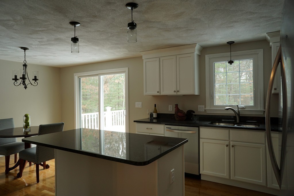 38 Blanchard Road Wilmington, MA 01887 - Photo 8 of 21 a kitchen with granite countertop a sink a window stainless steel appliances and cabinets