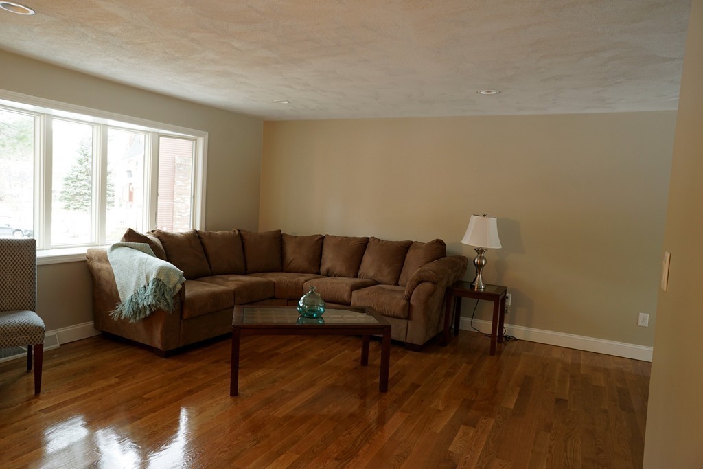 38 Blanchard Road Wilmington, MA 01887 - Photo 10 of 21 a living room with furniture and a wooden floor