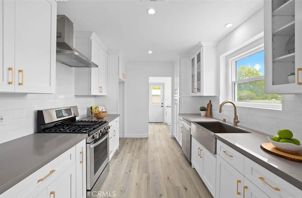 100 Eastern Pasadena, CA 91107 - Photo 11 of 18 a kitchen with granite countertop a sink a stove refrigerator and cabinets