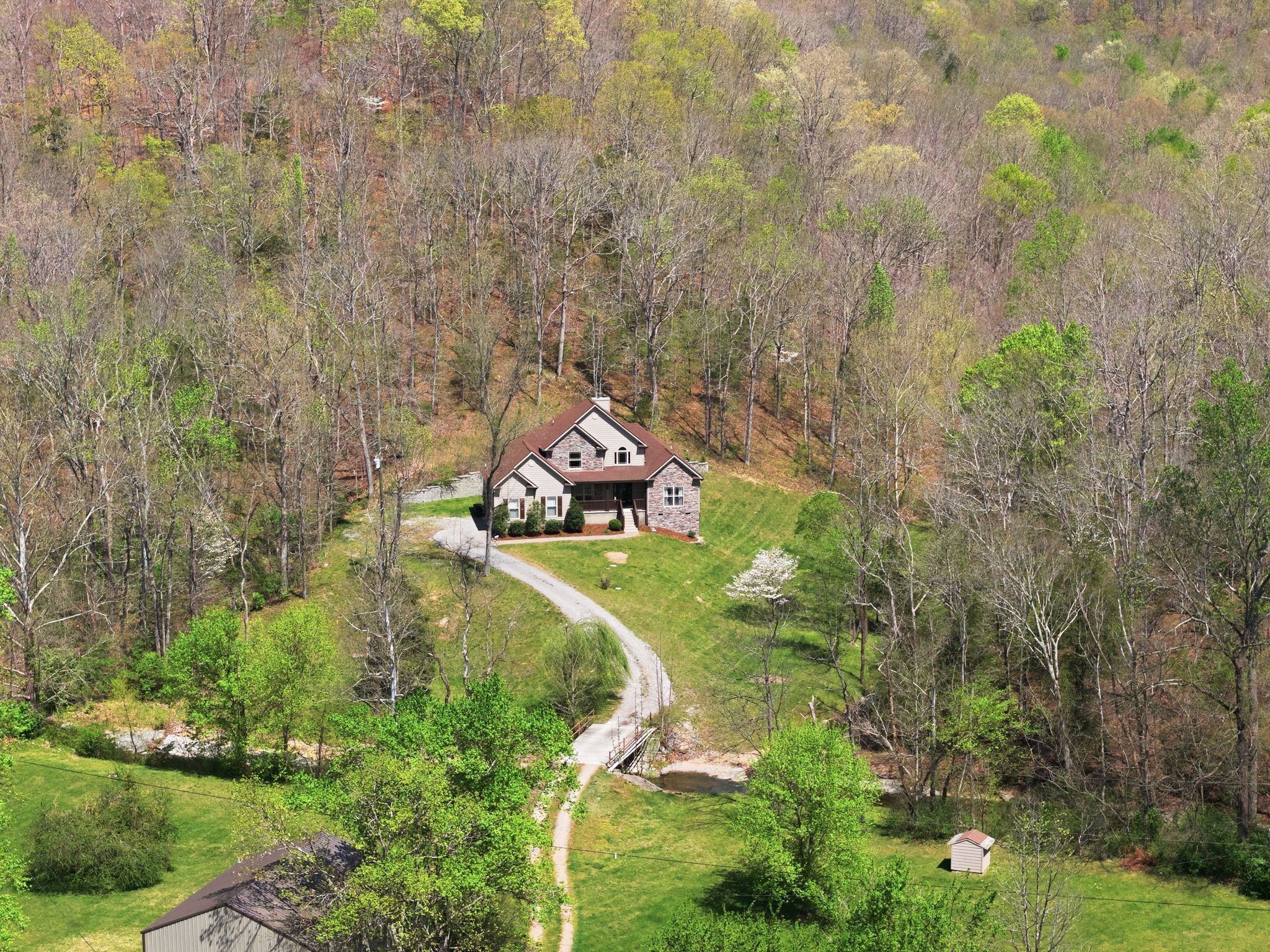 1075 Garland Hollow Road Pegram, TN 37143 - Photo 54 of 57 a aerial view of a house with a yard and large trees