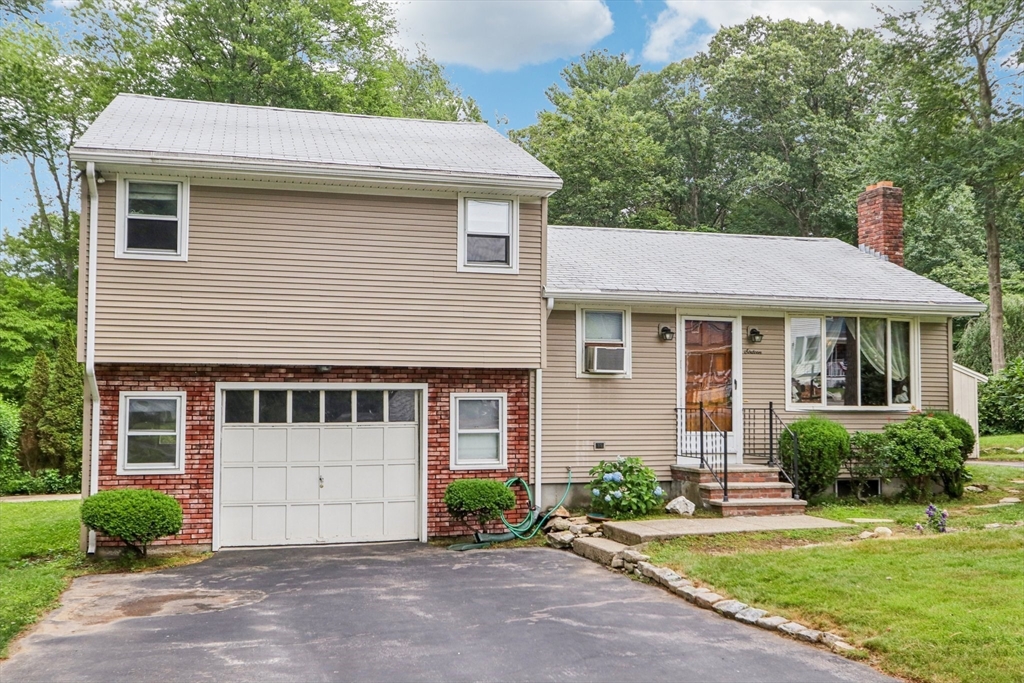 16 Indian Run Road Bellingham, MA 02019 - Photo 2 of 34 a front view of a house with a garden and plants