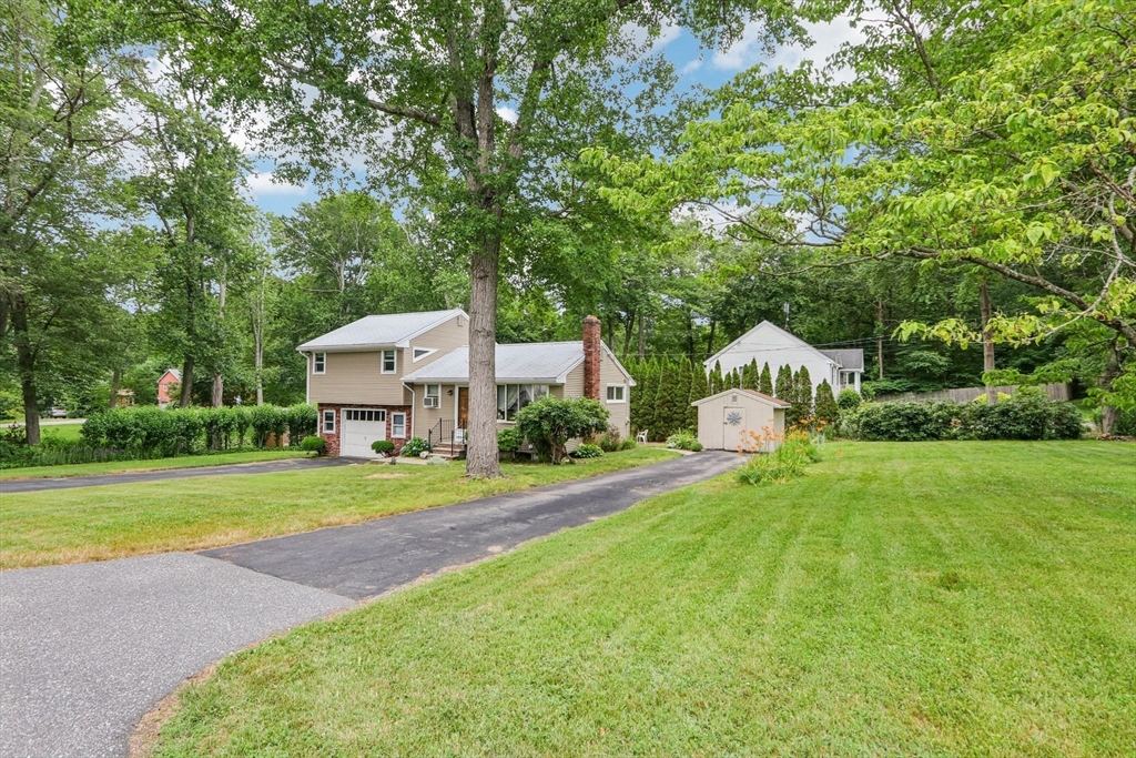 16 Indian Run Road Bellingham, MA 02019 - Photo 23 of 34 a front view of a house with a yard and trees