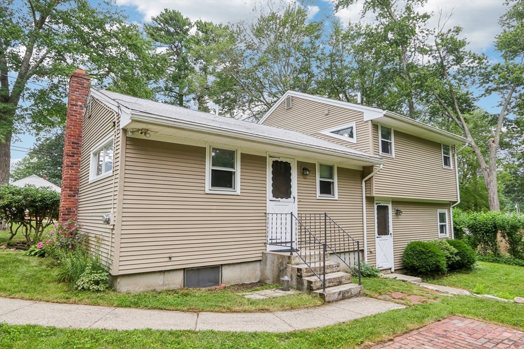 16 Indian Run Road Bellingham, MA 02019 - Photo 26 of 34 a front view of a house with a yard and garage