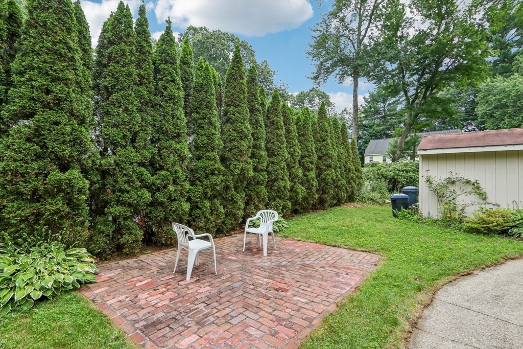 16 Indian Run Road Bellingham, MA 02019 - Photo 28 of 34 a white bench sitting in the middle of a garden