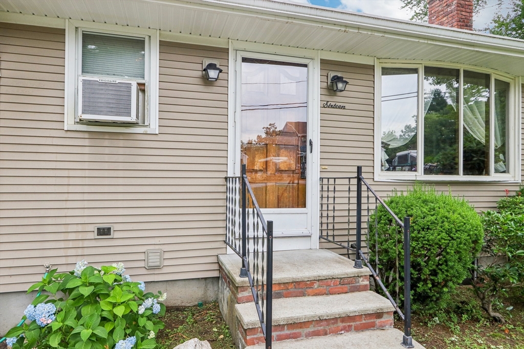 16 Indian Run Road Bellingham, MA 02019 - Photo 3 of 34 a front view of a house with a garden
