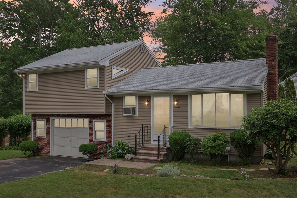 16 Indian Run Road Bellingham, MA 02019 - Photo 31 of 34 a front view of a house with a yard and potted plants