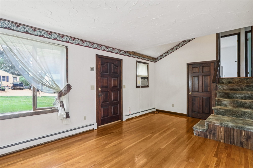 16 Indian Run Road Bellingham, MA 02019 - Photo 5 of 34 a view of an empty room with wooden floor and a window