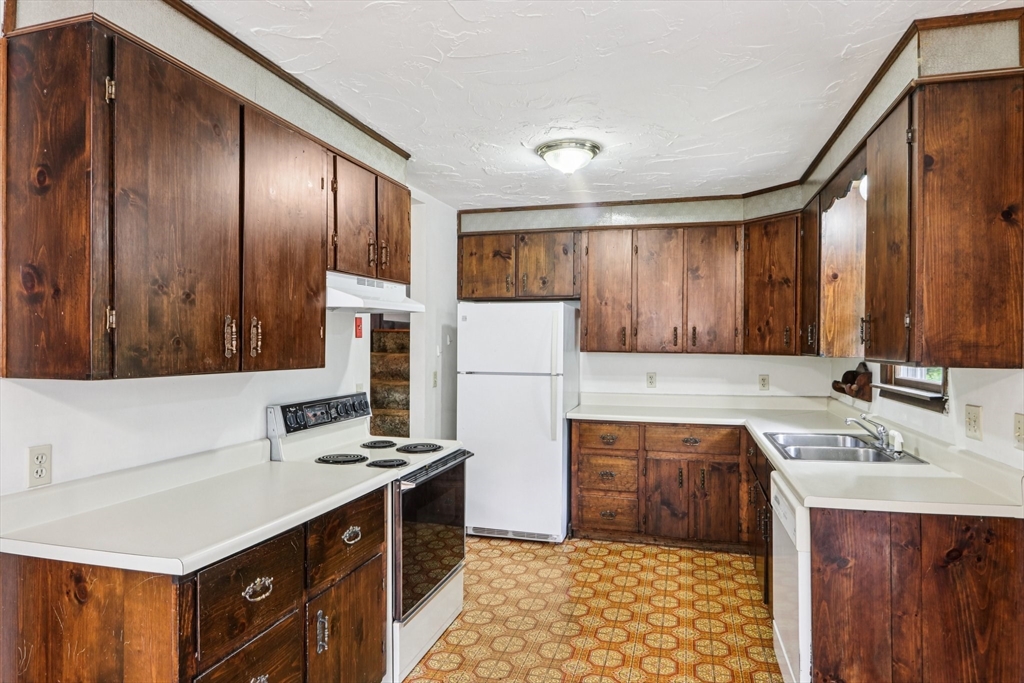16 Indian Run Road Bellingham, MA 02019 - Photo 8 of 34 a kitchen with a sink stove and refrigerator